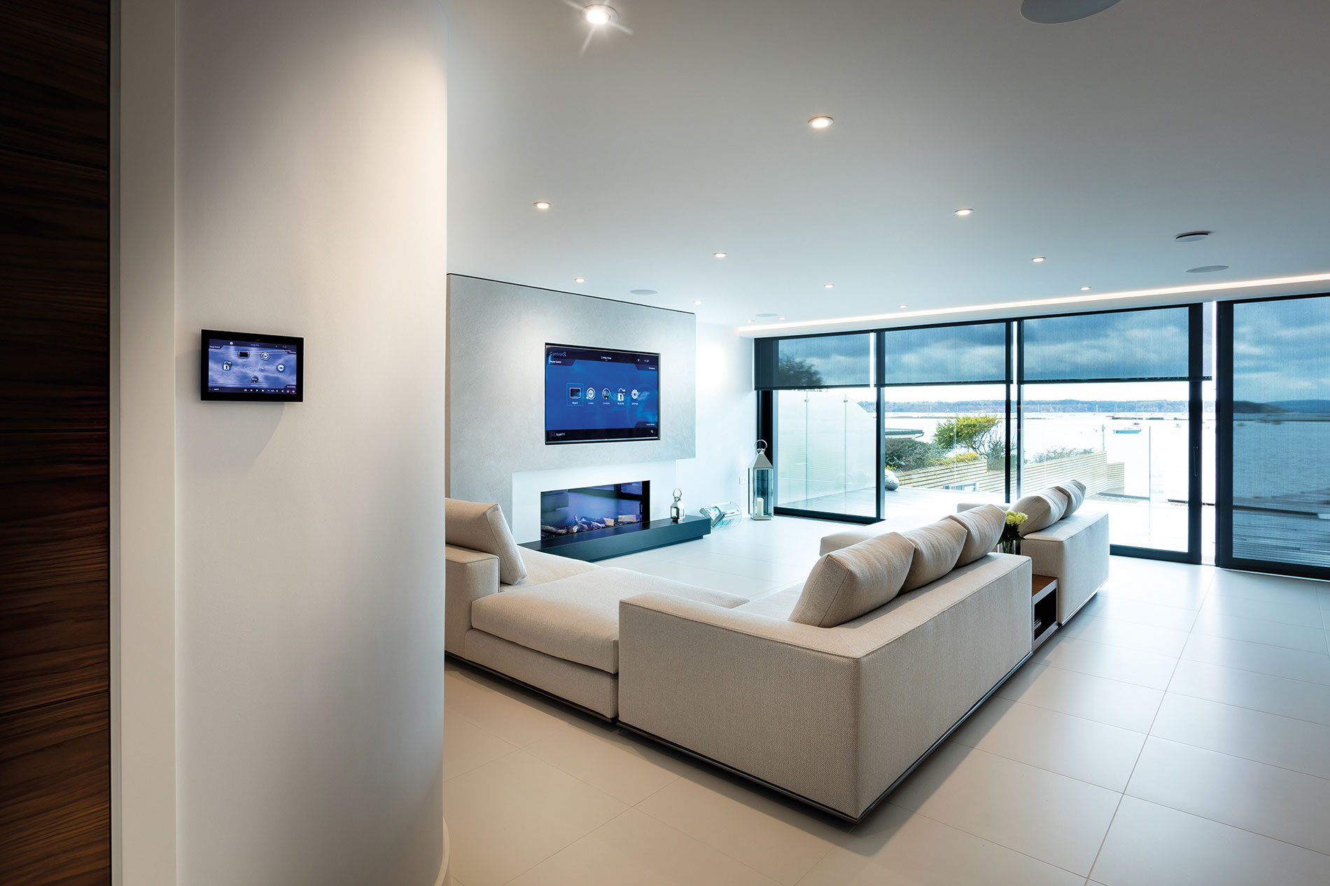 A waterfront Sandbanks living space with integrated audiovisual, lighting and shading